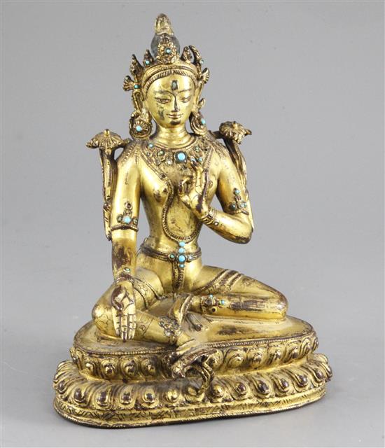 A Tibetan gilt copper alloy figure of Green Tara, 14th-15th century, height 21.3cm